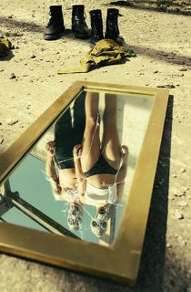 The World Beyond is a photographic project set in an apocalyptic scenario, a dystopian future in which our planet, now tired, old and victim of epidemics, natural disasters, pollution has now ceased to be what we knew. The air is now unbreathable and it is quite difficult to survive. This photographic story is set in this scenario, which sees two people as protagonists, a couple of young guy and girl, who try to survive in this hostile world full of pitfalls but poor in resources. The images want to represent a sort of story by expressing different emotional states that young people experience during their daily life. In this case exploring a new, abandoned and declining place to rest and refresh for some time in search of better accommodation along their path. The cut is purely cinematic especially for the particularity of the shots, plays of light and shadows, symmetries and depth.