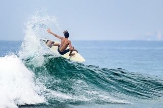 Серферы резвятся на пляже Хиккадувы. Шри-Ланка