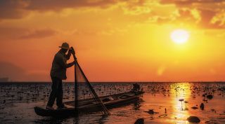 Fisherman of Lake in action when fishing, Thailand