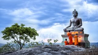 Novice Monk fire candles to the Buddha, Thialand