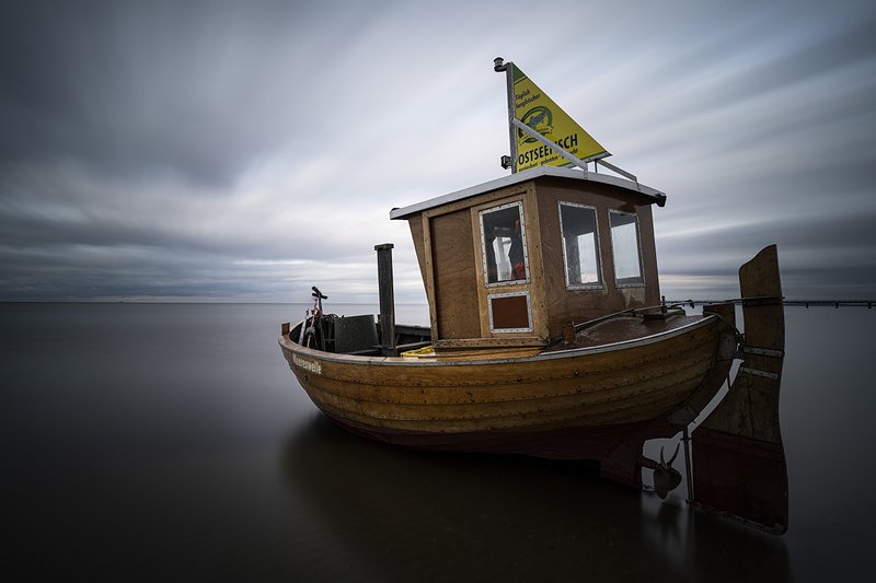 fishing boat, sea, sky, clouds, long exposure Abandoned on the sea coastphoto preview
