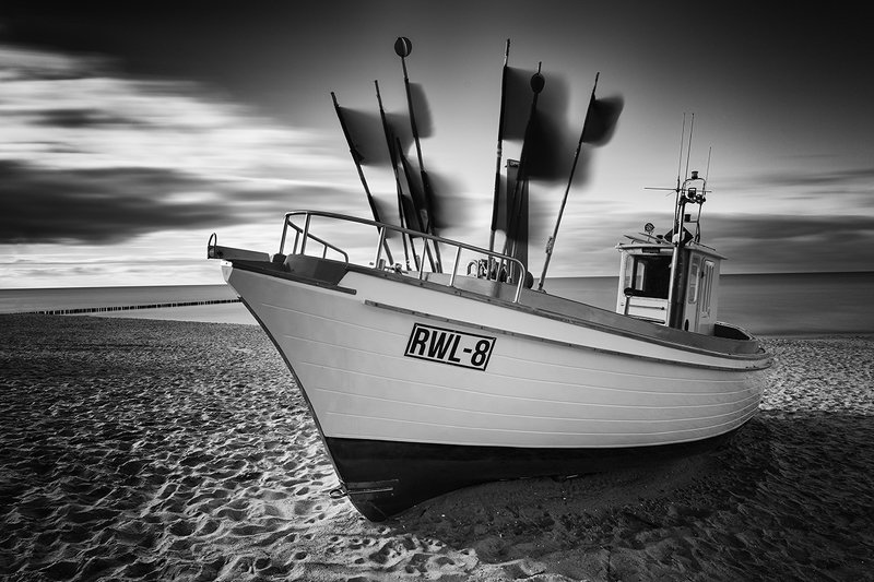 fishing boat, sea, black and white, sky, clouds, long exposure Under Flying Flagsphoto preview