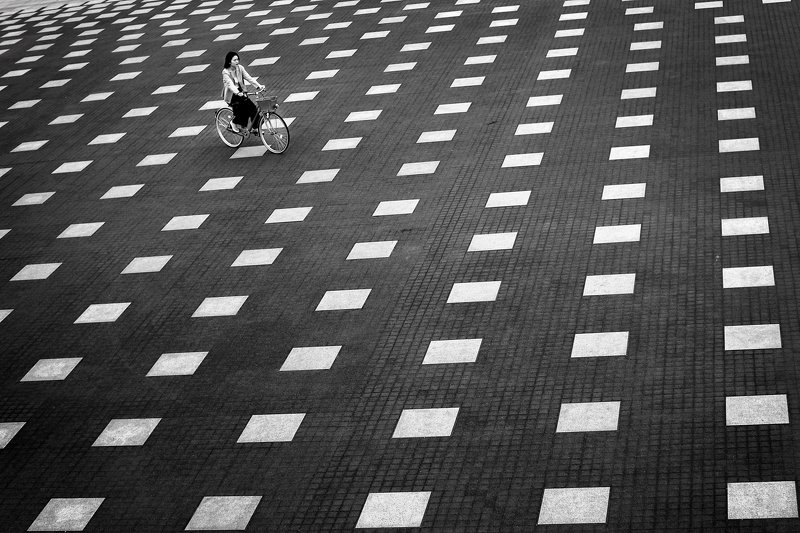 yancho sabev photography, monochrome, outdoor, Japan, high angle view, pattern, square, bicycle, black and white, one person ~ Lost In Squares ~photo preview