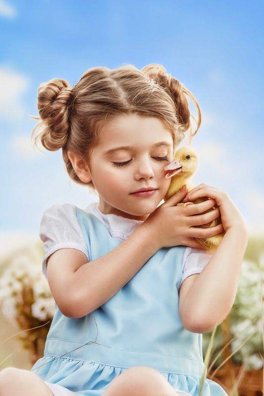 Little girl with duckling photo preview