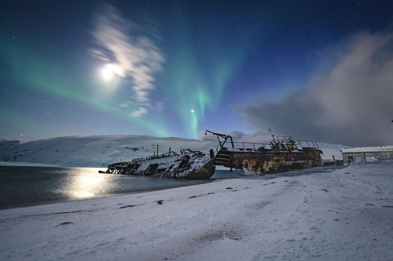 tundra; transportation; graveyard of ships; cloudy sky; tourism; beautiful; russian; outdoor; scenery; peninsula; barents; ocean; background; arctic circle; arctic ocean; bay; kola; northern; fishing boat; aurora; russia; ship; landscape; kola peninsula;  broken vessels on the coast of the Barents seaphoto preview