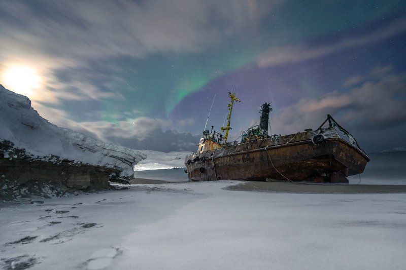 tundra; transportation; graveyard of ships; cloudy sky; tourism; beautiful; russian; outdoor; scenery; peninsula; barents; ocean; background; arctic circle; arctic ocean; bay; kola; northern; fishing boat; aurora; russia; ship; landscape; kola peninsula;  broken vessels on the coast of the Barents seaphoto preview