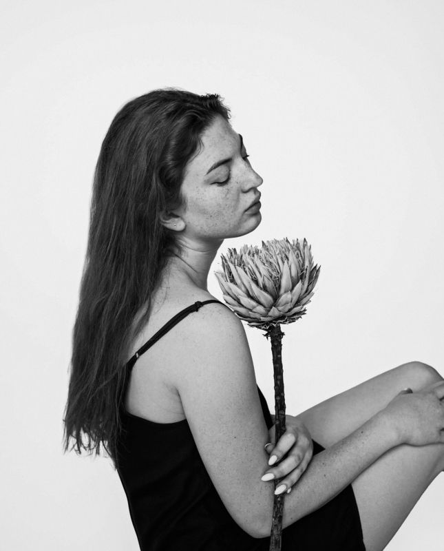 Freckled girl with flowerphoto preview