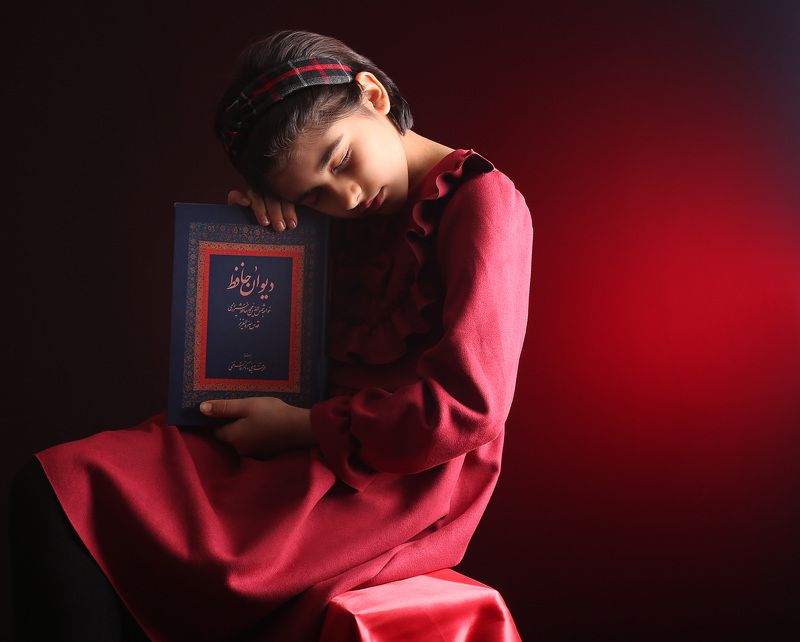 baby girle portrait Portrait of a little girl with Hafez\'s bookphoto preview