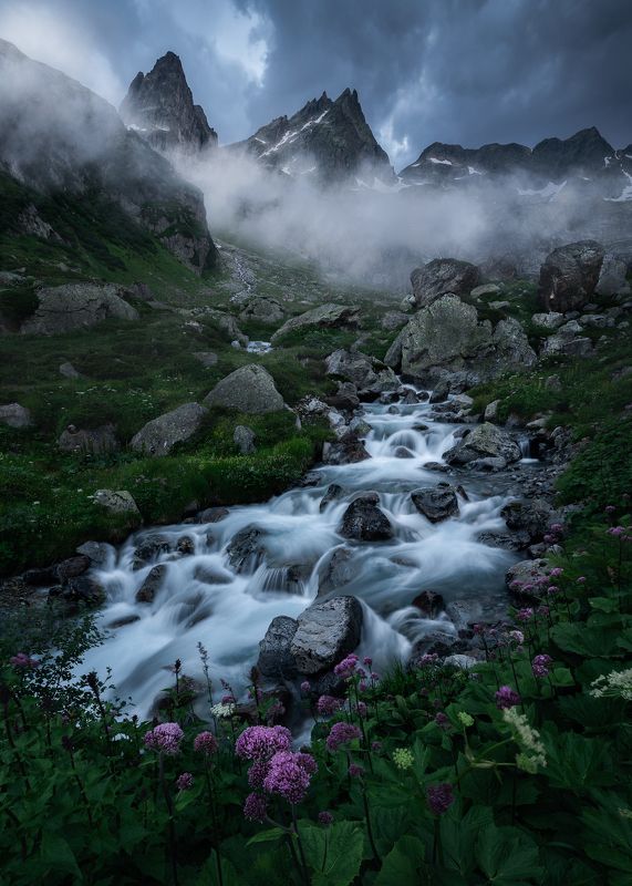 Landscape mountain moody blue hour waterfall river flowers spring Where the Stormbringer Sleepsphoto preview