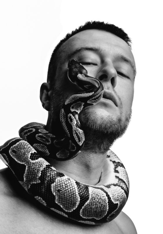 Black and white style portrait of man with snake facephoto preview