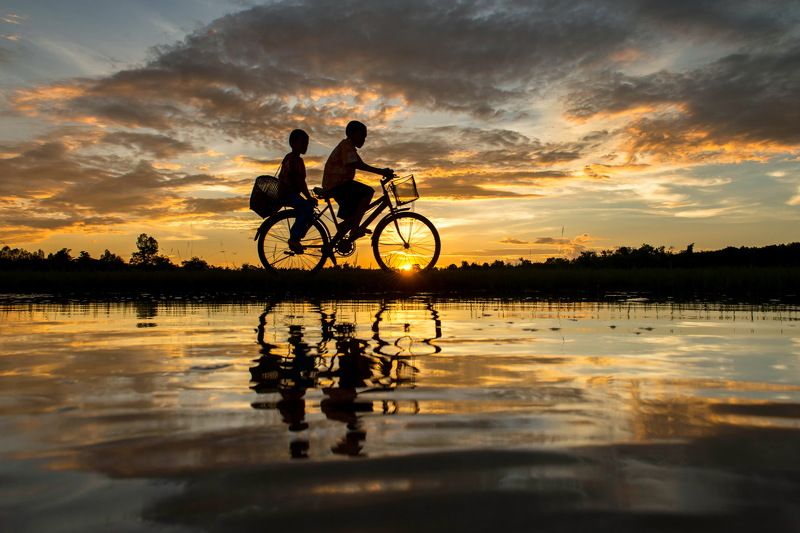Cycling, Bicycle, Scenics, Sunset, Reflection, Lake, People, Two People, Nature, Silhouette, Thailand, Atmospheric Mood, Beauty In Nature, Cloud - Sky, Color Image, Horizontal, On The Move, Outdoors, Photography, Sky, Sunlight, Togetherness, Transportatio Back Homephoto preview
