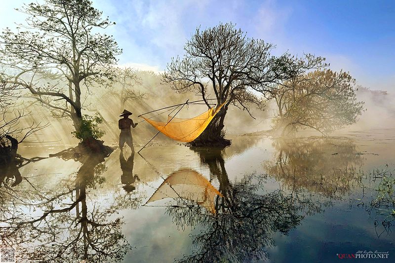 quanphoto, landscape, morning, autumn, forest, lagoon, fishing, fisherman, rays, reflections, rural, vietnam SunRays on an Autumn Morningphoto preview