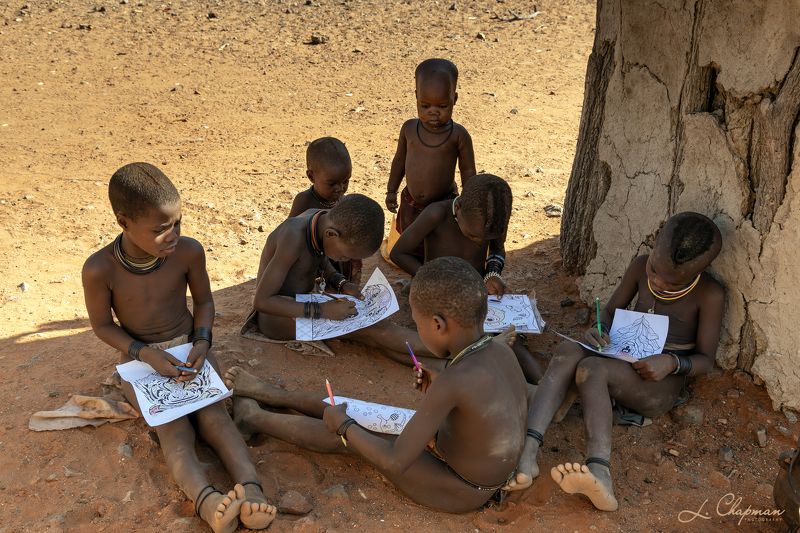 Himba Tribe boys doing homeworkphoto preview