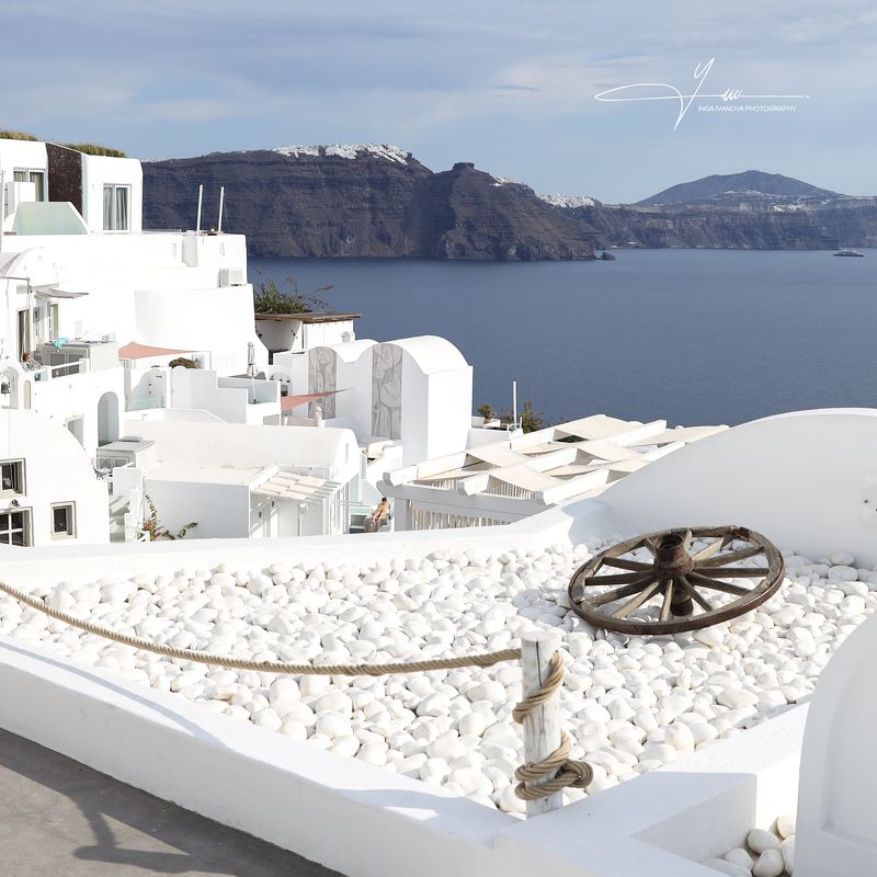 oia is a coastal town on the northwestern tip of santorini, a greek aegean island. the town has whitewashed houses carved into the rugged clifftops, and overlooks a vast caldera filled with water. santorini boasts its blue-and-white artwork. you may recog Santorini - Oiaphoto preview