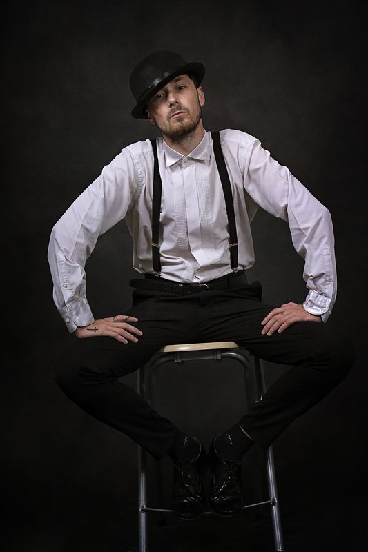 portrait, man, hat, suspenders, vintage style, theatrical, moody lighting, retro fashion, expression, character study          ask chatgpt Attitude in Silencephoto preview