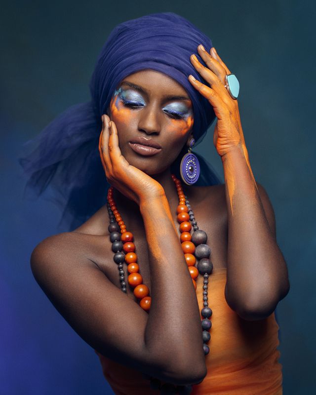 amber accents, artistic portrait, beautiful woman, blue backdrop, cinnamon shadows, delicate pose, desert muse, eastern adornment, exotic elegance, femininity, front view, golden hues, makeup, oriental portrait, turban, vintage orientalism, young woman Mirage of the Painted Princessphoto preview