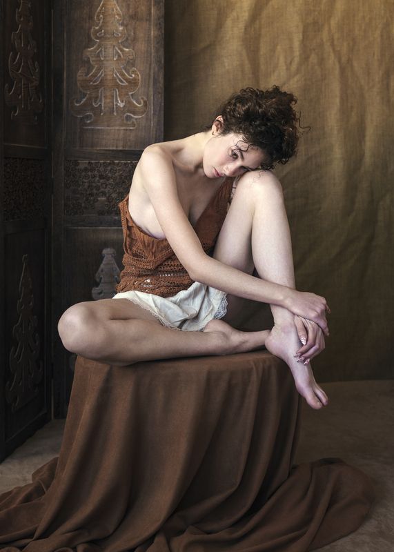 artistic photography, beautiful woman, brown tones, curly hair, delicate expression, emotional depth, front view, intimate portraiture, natural light, one person, painterly effect, poetic sensuality, thoughtful pose, vulnerable gaze, wooden screen The Angle of Waitingphoto preview