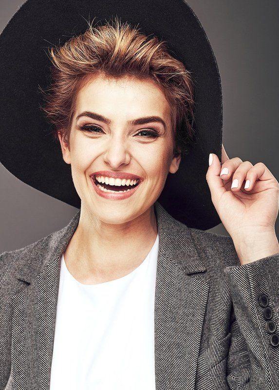 Portrait of a happy young woman in hat photo preview