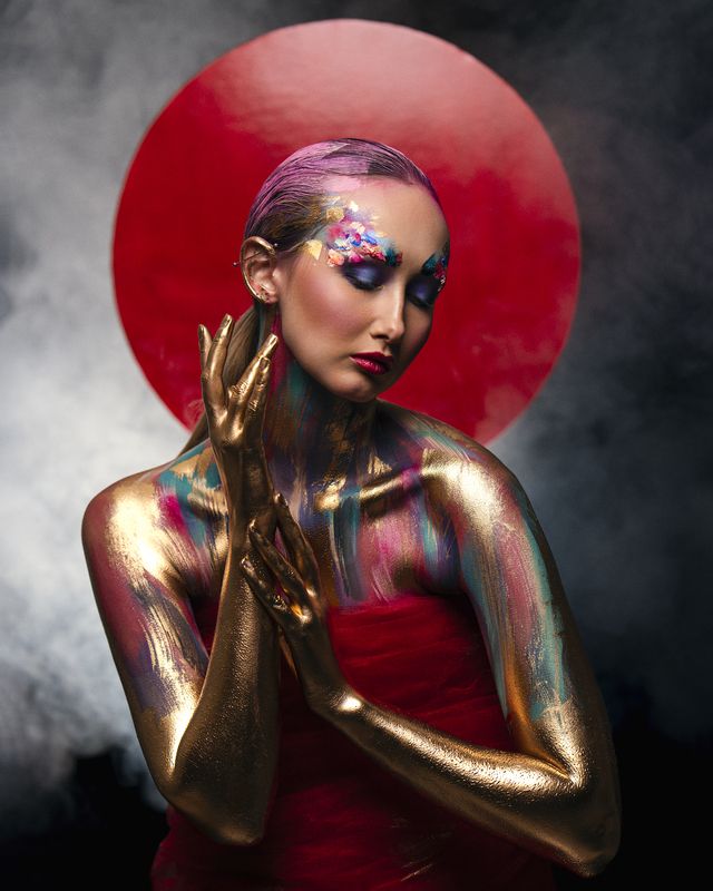 artistic portrait, body art, bold colors, chromatic texture, conceptual portrait, creative makeup, expressionist mood, fantasy styling, gilded skin, gold paint, hyperreal beauty, intense palette, painted body, pop surrealism, red halo, visual impact Celestial Iconphoto preview