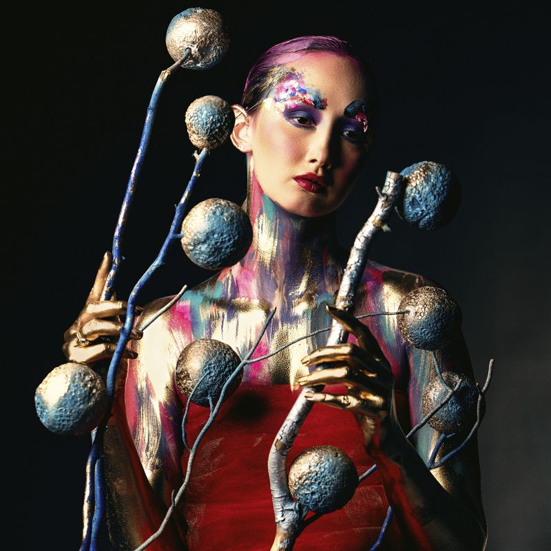 abstract fantasy, avant garde, body paint, creative makeup, fantasy styling, fine art, futuristic style, golden hands, luminous skin, metallic body, modern surrealism, painted skin, surreal imagery, symbolic elements, theatrical portrait, visual contrast Fruits of a Forgotten Cosmosphoto preview