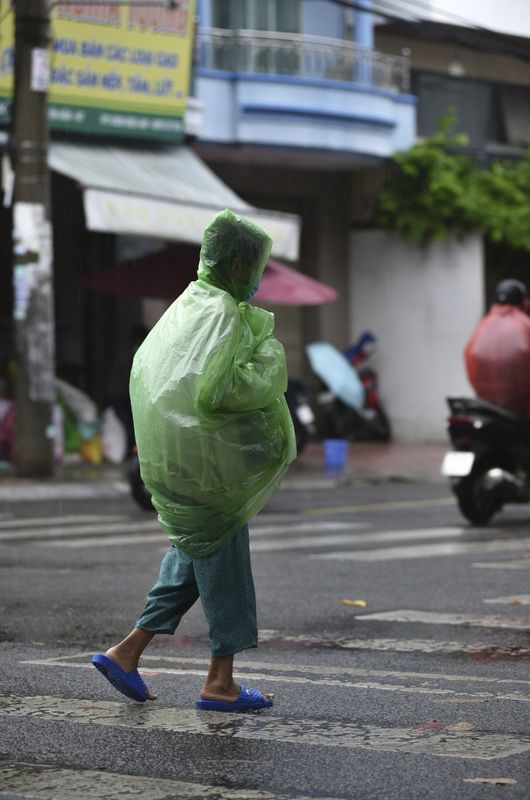 Raincoat on the VietNam streetsphoto preview