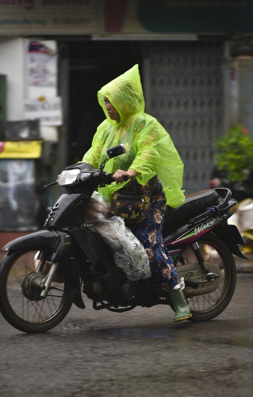 Raincoat on the VietNam streetsphoto preview