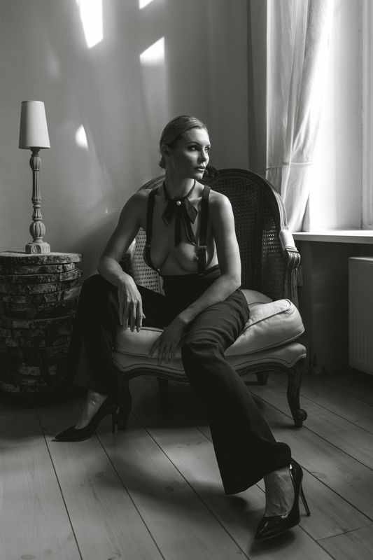 art nude, cinematic lighting, contemplative mood, dramatic shadows, elegant pose, feminine strength, high contrast, intimate portrait, minimal interior, monochrome style, noir style, sculptural form, sensual elegance, window light, woman portrait The Weight of Poisephoto preview