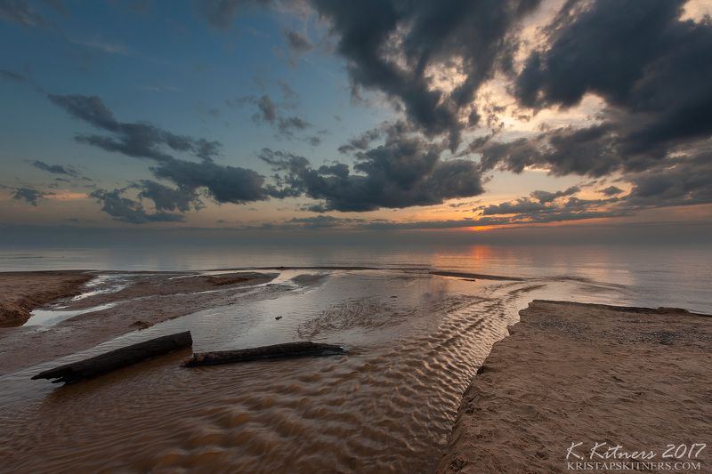sea seascape river water sky clouds branch coast beach sand sunset evening latvia At The Seaphoto preview