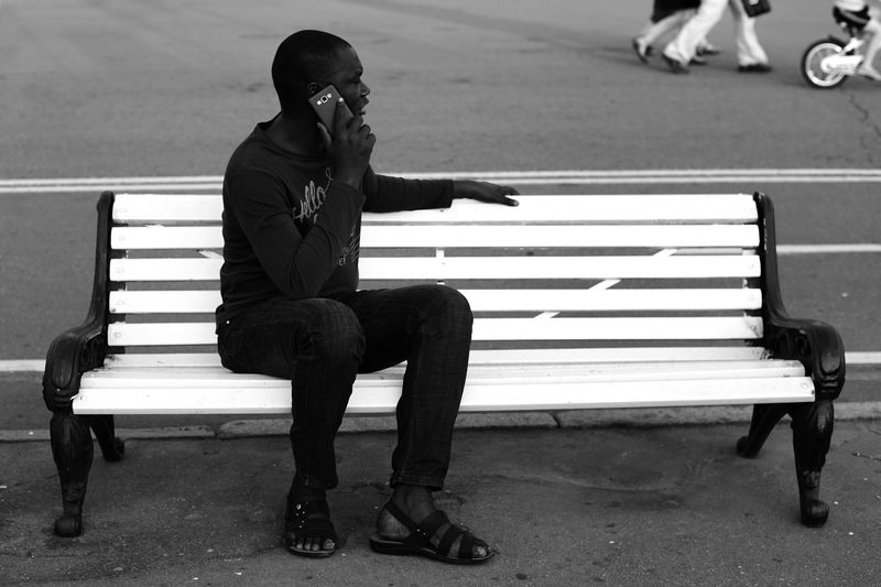 black man white banch street photo Black man on white benchphoto preview
