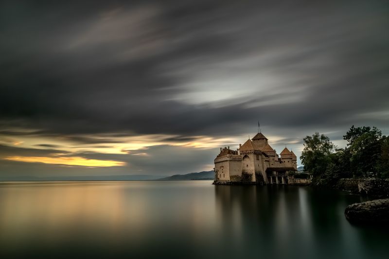 switzerland,chillon castle,long exposure,zeisss,lee filter,nikon d810,sunset,lake,genfersee,stone,tree,dramatic clouds chillon castlephoto preview