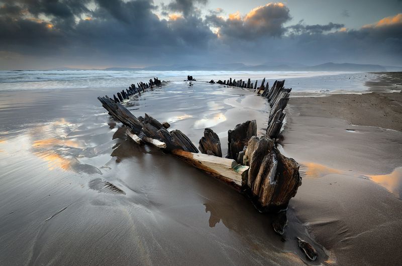 ireland, kerry, rossbeigh, sunset, wreck, boat, ship, beach, iconic, mountains. color, red The Sunbeamphoto preview
