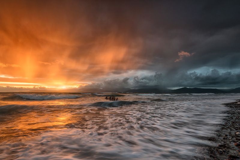 ireland, kerry, rossbeigh, sunset, wreck, boat, ship, beach, iconic, mountains. color, red Stormy Sunsetphoto preview