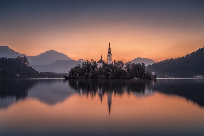 before sunrise, bled, blue, blue hour, calm waters, calmness, castle, church, church tower, cliff, clouds, forest, hills, island, lake, lake bled, lights, morning, mountain range, mountains, outdoors, reflections, rock, serenity, silence, sky, slovenia, s Awakening at Lake Bledphoto preview