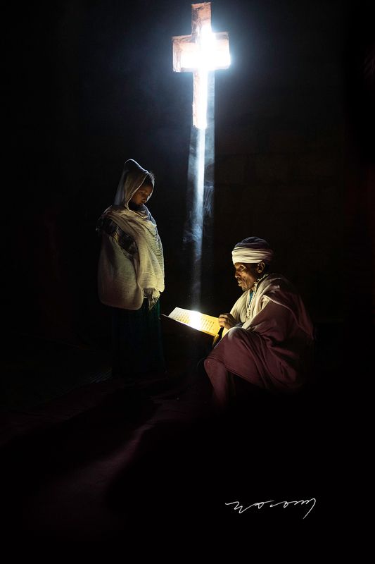 lalibela , ethiopia , orthodox church , monolithic rock-hewn , priest , girl , light  , the cross WORSHIPphoto preview