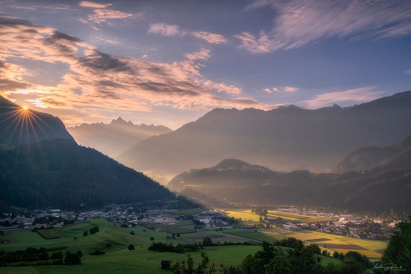 alps, austria, austrian alps, bridge, bushes, forest, grass, hauses, haze, hills, imst, inn valley, meadows, morning, morning light, morning mist, mountains, oetztal alps, outdoors, pitztal, road, sun, sunhaze, sunrays, sunrise, sunstar, tirol, town, wald Sunrise in the Alpsphoto preview