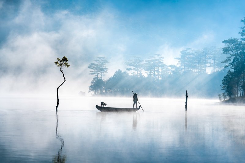 The ferryman and his pet on the lakephoto preview